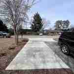 A car parked in the driveway of a home.