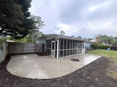 New concrete patio with screened porch.