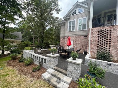 House patio with stone wall and seating.