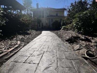 Stamped walkway with landscape and house in background