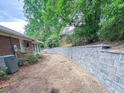 Retaining wall installed behind house.