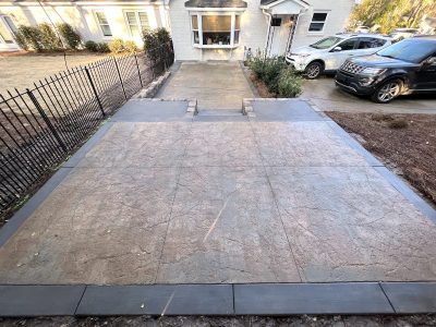 Decorative concrete patio with house in the background