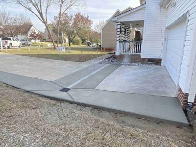 A driveway with a ramp going into the house.