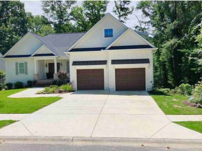 A house with two garage doors and a driveway.